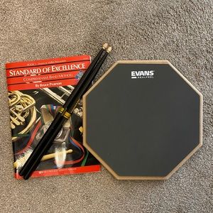 Drum Practice Pad (double sided), set of drumsticks and music instruction book
